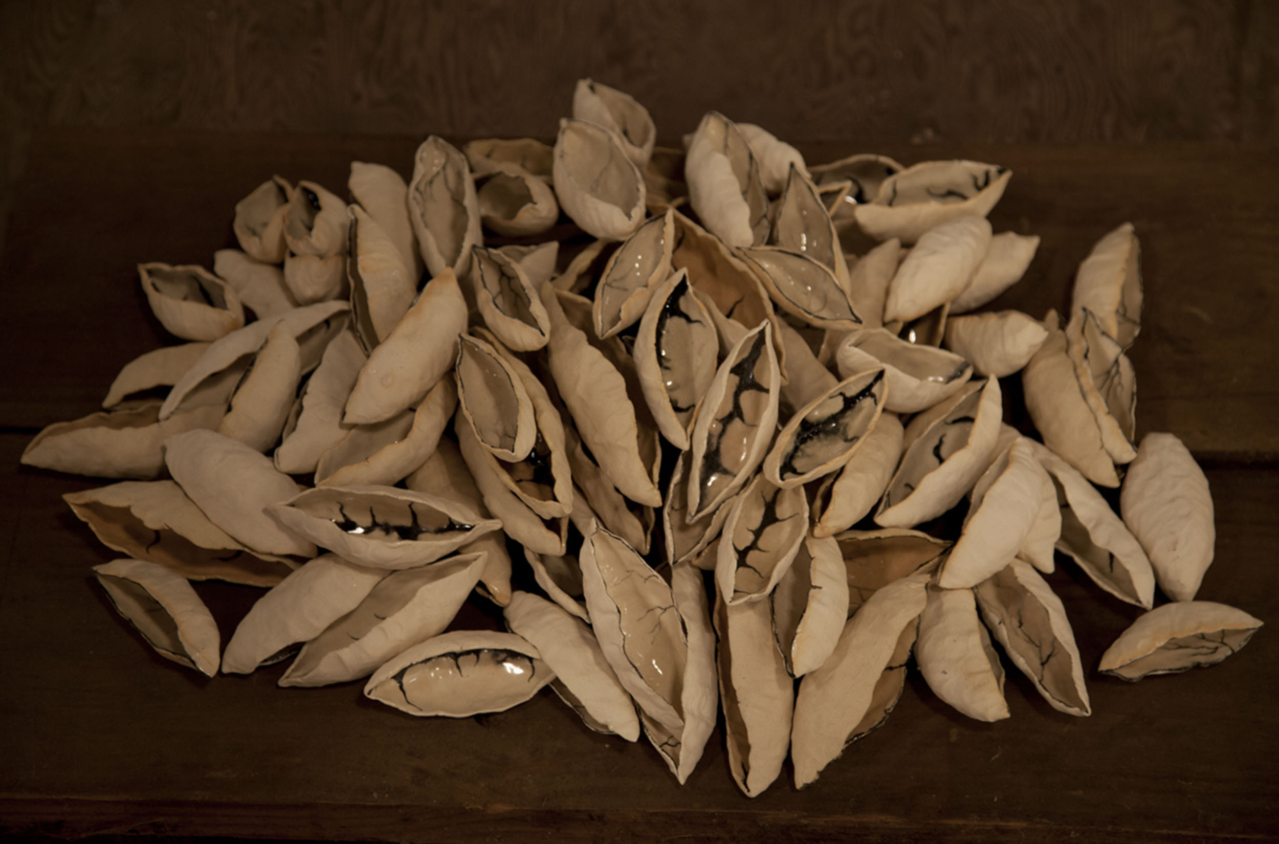 Ceramic depictions of seed pods in a large pile.