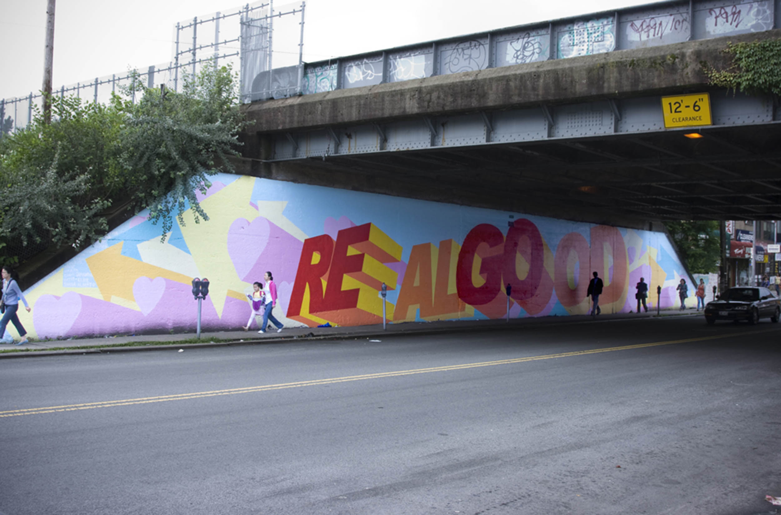 A rainbow-colored underpass mural featuring the words 